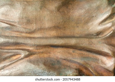 Close-up Photo Texture Of Copper Or Bronze Statue Material With Horizontal Folds.