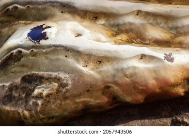 Close-up Photo Texture Of Copper Or Bronze Statue Material With Folds.