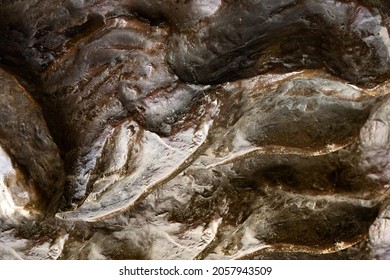 Close-up Photo Texture Of Copper Or Bronze Statue Material With Folds.