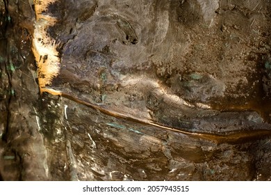 Close-up Photo Texture Of Copper Or Bronze Statue Material With Folds.