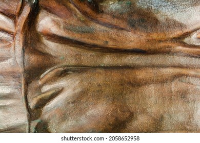 Close-up Photo Texture Of Copper Or Bronze Statue Material With Horizontal Folds.