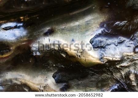 Close-up photo texture of copper or bronze statue material with folds.