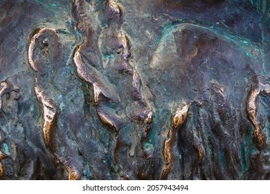 Close-up Photo Texture Of Worn And Aged Copper Or Bronze Statue Material With Folds.