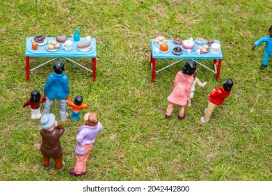 Closeup Photo Of Tiny Model Figures At A Fete