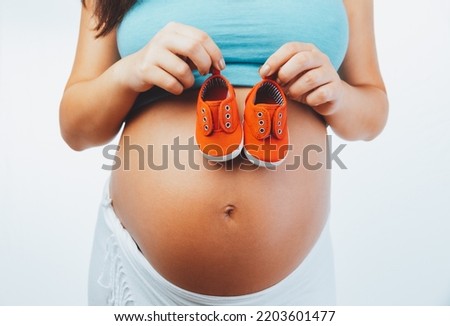 Similar – Image, Stock Photo Baby sneakers held by pregnant