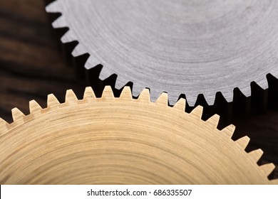 Closeup photo of two interlocking metal gears - Powered by Shutterstock