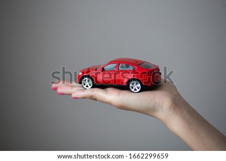 Closeup photo of woman hand holds a little car toy