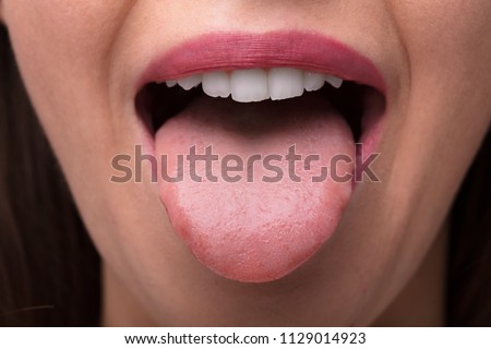 Close-up Photo Of A Woman Showing Tongue