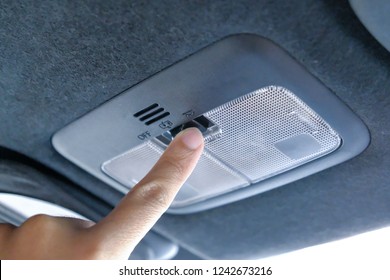 Closeup Photo Of Woman Turning Light On In Car Salon. Open Hand Lamp In Car.