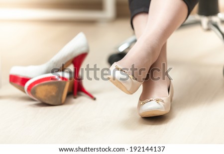 Closeup photo of woman wearing ballet flats instead of high heels