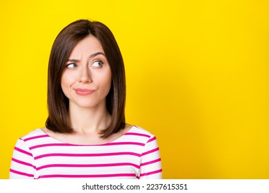 Closeup photo of young attractive beautiful woman play eyebrow looking empty space distrust isolated on yellow color background