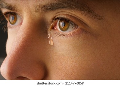 Closeup Photo Of Young Man Eye With A Tear. Man Crying