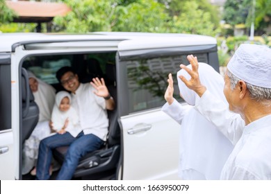 Closeup Photo Of Young Muslim Family With Kids Waving Hands Saying Goodbye To Grandparents Ready To Go Back Home After Celebrating Eid Mubarak Together