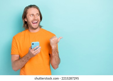 Closeup Photo Of Young Popular Handsome Guy Student Tiktok Blogger Positive Finger Directing Empty Space Interested Subscribe Isolated On Blue Color Background