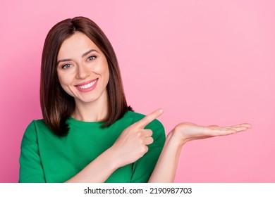 Closeup photo of young smiling woman hold hand new product advertisement recommend isolated on pink color background