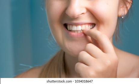 Closeup Photo Of Young Woman Checking Her Teeth At Bathroom