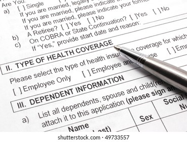 Close-up Photograph Of An Employee Group Health Insurance Application Form With Pen.