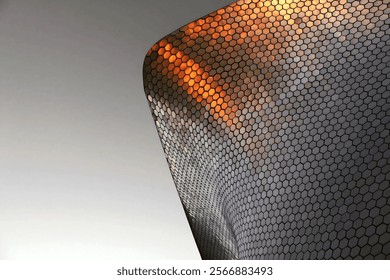 A close-up photograph of a modern building facade featuring a repeating hexagonal pattern, creating a visually striking and textured surface.