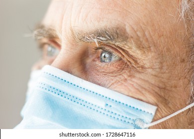 
Close-up Photograph Of The Pretty Blue Eyes Of An Older Person Wearing A Surgical Brace And Looking Into Infinity