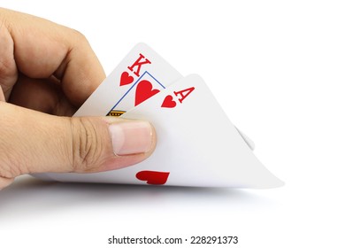 Closeup Photos That Focuses On The Black Jack With King Card And Ace Card Of Heart In The Hand On White Background