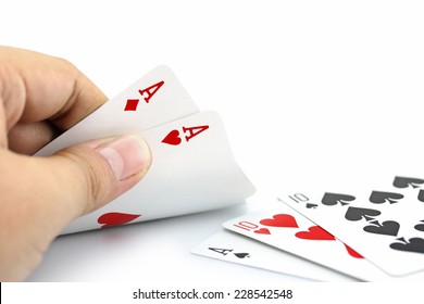 Closeup photos that focuses on two card of ace in hand,in poker game on white background
