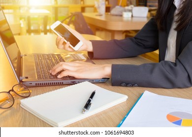 Close-up photos of young business woman or young woman owner While working and using a smartphone.Finances and economy concept. - Shutterstock ID 1061694803
