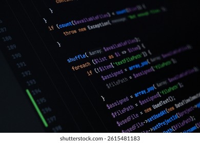 Close-up of PHP code displayed on a dark screen showing loop structures, array manipulation, and conditional logic for file assignment and data processing in a backend application
