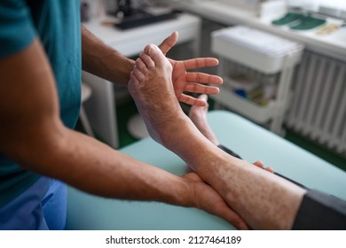 Close-up of physiotherapist exercising with senior patient's leg in a physic room. - Powered by Shutterstock