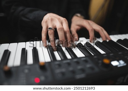 close-up of a pianist's hands while playing the piano
