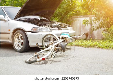 Closeup Picture Of A Car Crashes Into A White Bicycle On Road With Sun Flare.