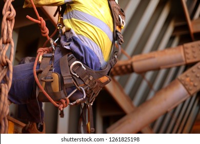 Closeup Picture Of Male Rope Access Inspector Worker Wearing Full Safety Harness Setting On A Chair, Abseiling Performing Wall Leaking Inspection Working At Height Construction Site, Sydney, Australia