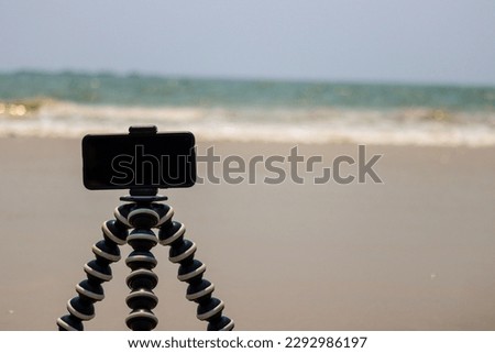 closeup picture of phone camera kept on a beach for time lapse recording