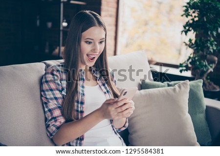Closeup picture photo of ecstatic rejoicing with opened mouth glad positive nice beautiful she her lady holding telephone cellular in hands watching gif image video