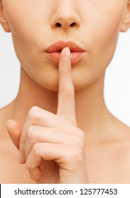 closeup picture of woman making a hush gesture