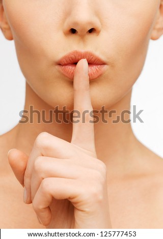 closeup picture of woman making a hush gesture