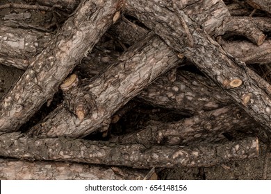 Closeup of a pile of chopped tree logs with rough textured bark. - Shutterstock ID 654148156