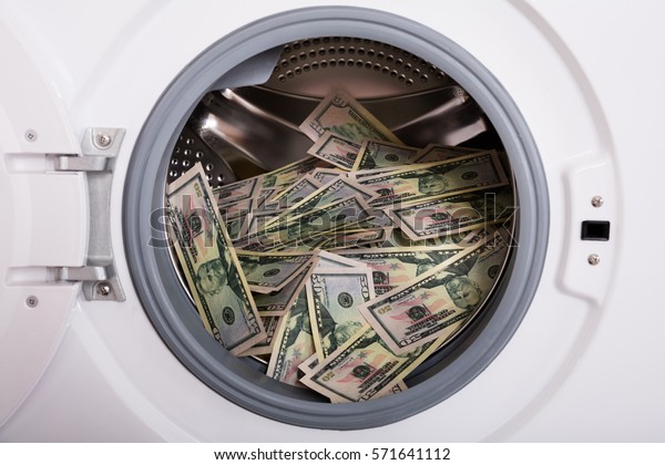 Close-up\
Of Pile Of Dirty Money Placed In Washing\
Machine
