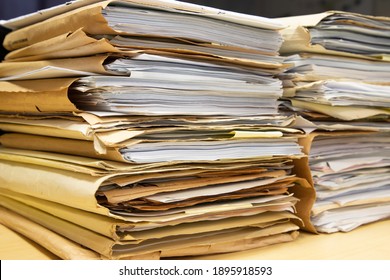 Close-up Of Piles Of Files Documents In Folders Stacking Up In A Messy Order.