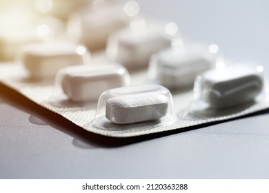 Closeup of pills in blister pack. Headache pills, painkillers, antibiotics or antidepressants tablets - Shutterstock ID 2120363288