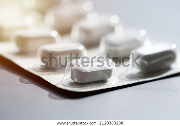 Closeup of pills in blister\
pack. Headache pills, painkillers, antibiotics or antidepressants\
tablets