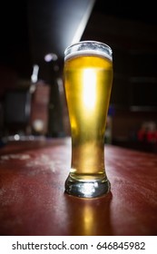 Close-up Of Pilsner Beer Glass On A Table