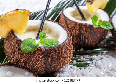 Closeup of pinacolada drink in the fresh coconut