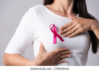 Closeup of pink badge ribbon on woman chest to support breast cancer cause.  - Shutterstock ID 1798539625