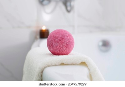 Close-up of a pink ball. bath bomb scented candle in the bathroom. The concept of therapy. Background with space to copy. Spa at home.