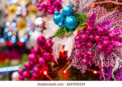 Closeup Of Pink And Blue Christmas Ornaments Decorated On A Geneva Style Christmas Tree. Blurred Bokeh Of Lights As Background. Displayed At A Local Shop Or Department Store For Sale.