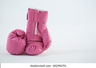 Close-up of pink boxing gloves pair against white background - Shutterstock ID 692396791