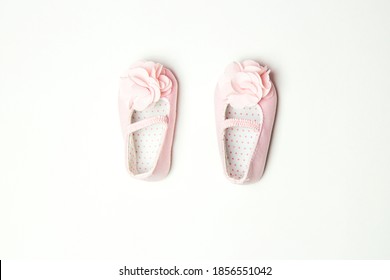 Close-up Of Pink Sandals With A Flower For A Little Girl. First Shoes For Baby Girl On A Light Background With Space For Text. Top View. Baby Shower Party