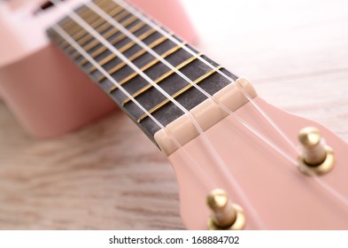 Closeup of a pink ukulele