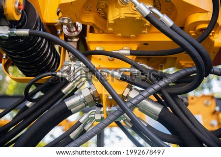 Closeup pipe system high pressure hydraulic valves in mining machinery.