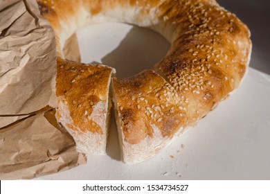 Closeup Of Pita Bread Pastry In A Paper Bag Seasoned With Sesame Seeds On A White Background